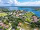 Scenic aerial view of a home nestled near a lake, surrounded by lush greenery and neighborhood charm at 5704 Bay Side Dr, Orlando, FL 32819