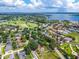 Expansive aerial view of home in a lush community with mature trees, golf course and lake views at 5704 Bay Side Dr, Orlando, FL 32819