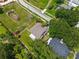 Aerial shot of a well-maintained yard showing the roof and a small pond at the edge of the lot at 5704 Bay Side Dr, Orlando, FL 32819