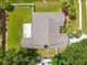 Aerial view of backyard with a mix of green lawn, partial shade, and a view of surrounding green spaces at 5704 Bay Side Dr, Orlando, FL 32819
