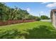 Spacious backyard with a well-maintained lawn and a brick wall border at 5704 Bay Side Dr, Orlando, FL 32819