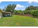 Beautiful backyard with manicured lawn, patio, and privacy fence at 5704 Bay Side Dr, Orlando, FL 32819