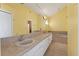 Bright bathroom with double sinks, a large mirror, and a soaking tub at 5704 Bay Side Dr, Orlando, FL 32819