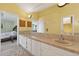 Bright bathroom with dual sinks, tiled countertops, and neutral-colored walls at 5704 Bay Side Dr, Orlando, FL 32819