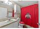 Bathroom featuring Ohio State Buckeyes decor, a vanity, and a shower with a Buckeye curtain at 5704 Bay Side Dr, Orlando, FL 32819
