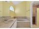 A bright bathroom featuring a soaking tub and separate walk-in shower at 5704 Bay Side Dr, Orlando, FL 32819