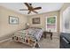Cozy bedroom with ceiling fan, a window, and quilt-covered bed, offering a serene and inviting atmosphere at 5704 Bay Side Dr, Orlando, FL 32819