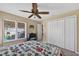 Comfortable bedroom with closet, ceiling fan and a window offering backyard views at 5704 Bay Side Dr, Orlando, FL 32819