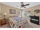 Inviting bedroom featuring a ceiling fan, windows for natural light, and a comfortable quilt-covered bed at 5704 Bay Side Dr, Orlando, FL 32819
