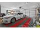 Well-organized garage featuring a car, red and gray tiled flooring, and ample storage shelving at 5704 Bay Side Dr, Orlando, FL 32819