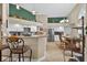 Open kitchen features white cabinets, granite countertops, and a breakfast bar with stool seating at 5704 Bay Side Dr, Orlando, FL 32819