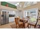 Kitchen with stainless steel appliances, granite counters, white cabinets, eat-in-kitchen table, and large window at 5704 Bay Side Dr, Orlando, FL 32819
