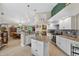 Bright, open kitchen with granite counters, central island, modern appliances, and seamless connection to the living spaces at 5704 Bay Side Dr, Orlando, FL 32819