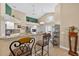 Bright open kitchen features white cabinetry, granite countertops, and a view to the outdoor patio at 5704 Bay Side Dr, Orlando, FL 32819