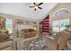 Cozy living room featuring a ceiling fan, large windows, and comfortable furniture at 5704 Bay Side Dr, Orlando, FL 32819