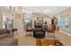 Inviting living room featuring open layout, neutral color scheme, comfortable seating, and tile flooring at 5704 Bay Side Dr, Orlando, FL 32819