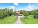 Expansive aerial view of a two-story home on a large lot featuring mature trees and a gated entrance at 6346 Dallas Blvd, Orlando, FL 32833