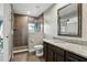 Well-lit bathroom with a granite vanity, large mirror and walk-in shower at 6346 Dallas Blvd, Orlando, FL 32833