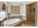 Stunning bathroom with a large soaking tub, a walk-in shower, and stylish decor at 6346 Dallas Blvd, Orlando, FL 32833
