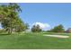 Scenic view of a beautifully landscaped golf course with mature trees, green fairways, and white sand bunkers at 6346 Dallas Blvd, Orlando, FL 32833