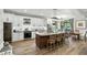 Bright kitchen featuring white cabinets, stainless steel appliances, granite countertops, and a large island at 6346 Dallas Blvd, Orlando, FL 32833
