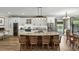 Modern kitchen with white cabinets, stainless steel appliances, a large island with seating, and stylish pendant lighting at 6346 Dallas Blvd, Orlando, FL 32833