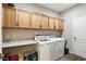 Functional laundry room with modern washer/dryer units and ample storage at 6346 Dallas Blvd, Orlando, FL 32833