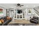 Spacious living room featuring a fireplace, built-in shelves, hardwood floors, and comfortable leather seating at 6346 Dallas Blvd, Orlando, FL 32833