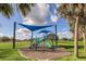 Colorful playground featuring slides, climbing structures, and a protective shade canopy for a safe and fun experience at 6346 Dallas Blvd, Orlando, FL 32833