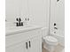 Modern bathroom features a white vanity with a stone countertop and black matte fixtures at 709 Marion Oaks Mnr, Ocala, FL 34473