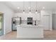 Modern kitchen featuring an island with pendant lighting, stainless steel appliances, and white cabinets at 709 Marion Oaks Mnr, Ocala, FL 34473