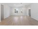 Bright living area featuring light wood floors, white walls, and a view of the front entrance at 709 Marion Oaks Mnr, Ocala, FL 34473