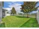 Large, well-maintained backyard with lush grass, shade trees, and white fencing for outdoor enjoyment at 7895 Pleasant Pine Cir, Winter Park, FL 32792