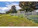 Spacious backyard with a white fence, mature trees providing shade and privacy for outdoor activities at 7895 Pleasant Pine Cir, Winter Park, FL 32792