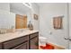 Cozy bathroom with a single sink vanity and decorative mirror at 7895 Pleasant Pine Cir, Winter Park, FL 32792