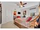 Bedroom with carpet floors, TV, ensuite bathroom, and a ceiling fan at 7895 Pleasant Pine Cir, Winter Park, FL 32792