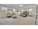 Spacious bedroom boasts natural light, stylish furniture, and ample space for relaxation and rest at 7895 Pleasant Pine Cir, Winter Park, FL 32792