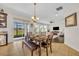 Cozy dining area with a dark wood table, bench seating, and sliding glass doors that lead to outdoor space at 7895 Pleasant Pine Cir, Winter Park, FL 32792