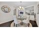 Bright dining area with a glass table, elegant chairs, and a stylish chandelier for a luxurious dining experience at 7895 Pleasant Pine Cir, Winter Park, FL 32792