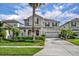 Two-story home showcasing manicured landscaping, a two-car garage and a welcoming front entrance at 7895 Pleasant Pine Cir, Winter Park, FL 32792