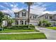 Two-story home showcasing manicured landscaping, a two-car garage and a welcoming front entrance at 7895 Pleasant Pine Cir, Winter Park, FL 32792