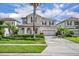 Two-story home showcasing manicured landscaping, a two-car garage and a welcoming front entrance at 7895 Pleasant Pine Cir, Winter Park, FL 32792