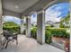 Inviting front porch featuring a covered entrance, neutral colors, and comfortable seating at 7895 Pleasant Pine Cir, Winter Park, FL 32792