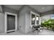 Inviting front porch featuring a covered entrance, neutral colors, and comfortable seating at 7895 Pleasant Pine Cir, Winter Park, FL 32792