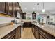 Gourmet kitchen with dark wood cabinetry, stainless steel appliances, and ample counter space for cooking and prep at 7895 Pleasant Pine Cir, Winter Park, FL 32792