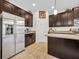 Spacious kitchen with stainless steel appliances, dark cabinets, and ample counter space, perfect for culinary enthusiasts at 7895 Pleasant Pine Cir, Winter Park, FL 32792