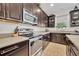 Well-designed kitchen featuring stainless steel appliances, dark wood cabinets, and ample counter space for all cooking needs at 7895 Pleasant Pine Cir, Winter Park, FL 32792