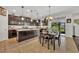 Spacious kitchen featuring dark wood cabinets, a large center island, and an adjacent dining area with outdoor views at 7895 Pleasant Pine Cir, Winter Park, FL 32792