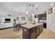 Open concept kitchen with a central island, dining area, and seamless flow into the living room, perfect for entertaining at 7895 Pleasant Pine Cir, Winter Park, FL 32792