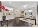 Bright living room featuring hardwood floors, neutral colors, and access to the dining area at 7895 Pleasant Pine Cir, Winter Park, FL 32792